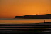 The sun sets over Camber Sands.