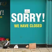 A homeless person sleeps in the doorway of a closed-down Poundland store in York, north west England on January 6, 2021, on the second day of Britain's national lockdown to combat the spread of COVID-19. - England went back into full lockdown as Europe battled Wednesday to stem a rising tide of coronavirus cases, and the United States logged its worst daily death toll of the pandemic. (Photo by Oli SCARFF / AFP) (Photo by OLI SCARFF/AFP via Getty Images)