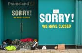 A homeless person sleeps in the doorway of a closed-down Poundland store in York, north west England on January 6, 2021, on the second day of Britain's national lockdown to combat the spread of COVID-19. - England went back into full lockdown as Europe battled Wednesday to stem a rising tide of coronavirus cases, and the United States logged its worst daily death toll of the pandemic. (Photo by Oli SCARFF / AFP) (Photo by OLI SCARFF/AFP via Getty Images)