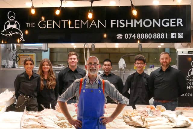 Martyn Pippard in front of his stall with staff.