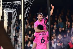 George  Miller celebrates a goal with Ro-Shaun Williams.