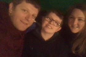 Rhys, centre, with his dad Dwayne and mum Stacey.
