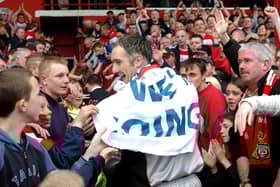 Andy Warrington, pictured in 2004 celebrating winning the Division Three title.