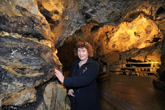 Vicky Turner MD of the Treak Cliff Cavern, Castleton Peak District looking one of the seams of Blue John Stone in the cavern in 2013