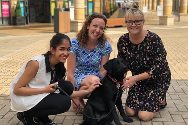 Lakeside Village’s deputy centre manager Lyndsey Parry (far right) with one of the previous guide dogs the centre has sponsored