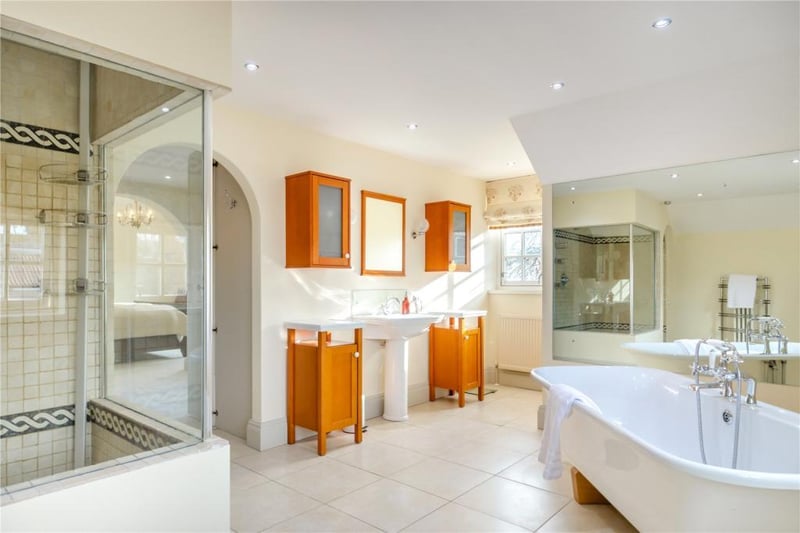 A swish bathroom with free standing bath and separate walk-in shower.