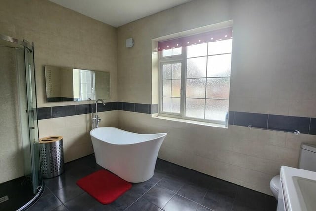 One of three contemporary bath and shower rooms on the first floor.
