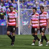 CChris Brown, Enda Stevens and Gabriel Tamas leave the pitch at Leicester dejected after Rovers' relegation