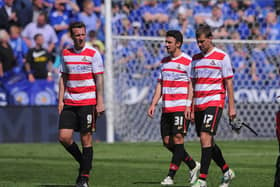 CChris Brown, Enda Stevens and Gabriel Tamas leave the pitch at Leicester dejected after Rovers' relegation