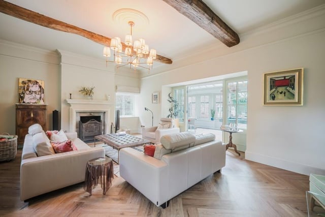 A beamed reception room with feature fireplace.