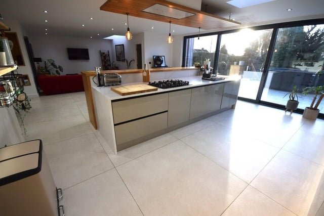 The modern, open plan kitchen with bi-fold doors to an outdoor patio.