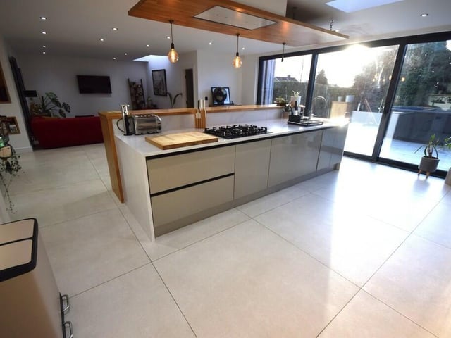 The modern, open plan kitchen with bi-fold doors to an outdoor patio.