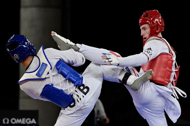 Bradly Sinden (red) in action against Uzbekistan's Ulugbek Rashitov. Photo by JAVIER SORIANO/AFP via Getty Images