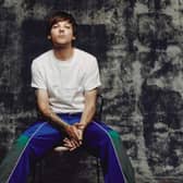 Doncaster's Louis Tomlinson says the first One Direction album was "s***"