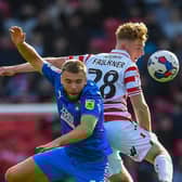 No messing: Doncaster Rovers starlet Bobby Faulkner wins a header against Leyton Orient.