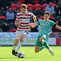 Doncaster's Bobby Faulkner drives forward with the ball against Swindon Town.