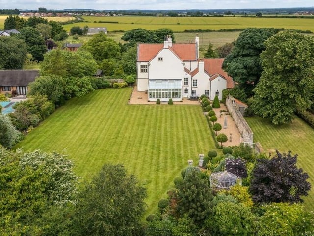 An overview of the property with its south-facing gardens, from the rear.