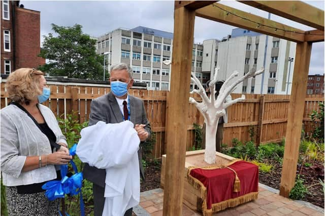 Diane Smith and Richard Parker unveil the new Rainbow Garden at DRI.