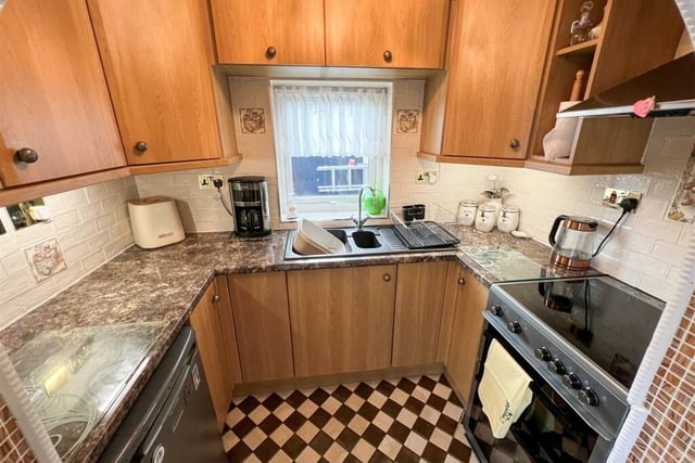 The property's kitchen with a range of fitted units.