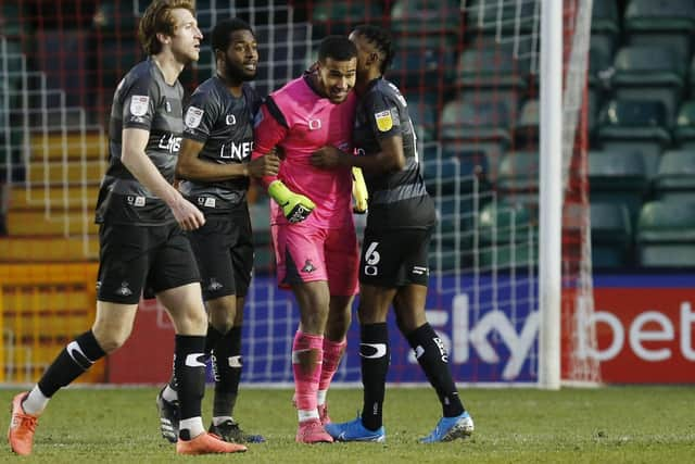 Ellery Balcombe is congratulated after his double penalty save against Lincoln