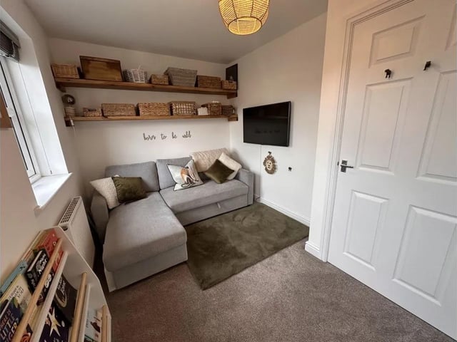 Another bedroom, currently used as a sitting or reading room.