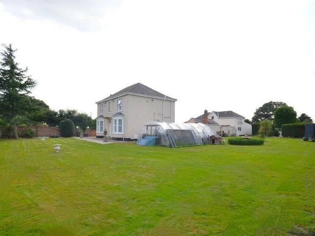 View of the property from its extensive lawned gardens.