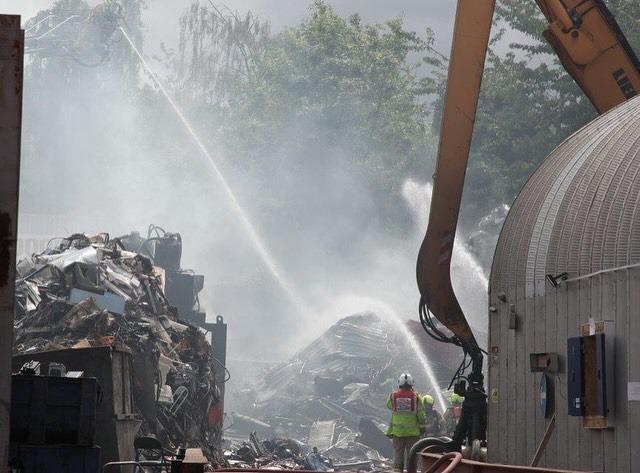 Flames tore through a pile of waste metal at the site.