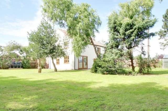 The property covers 15 acres of land, with stunning stretches of lawn and a variety of trees.