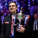 Ronnie O’Sullivan poses with the Betfred World Snooker Championship trophy after beating Judd Trump in the final. Photo: Lewis Storey/Getty Images