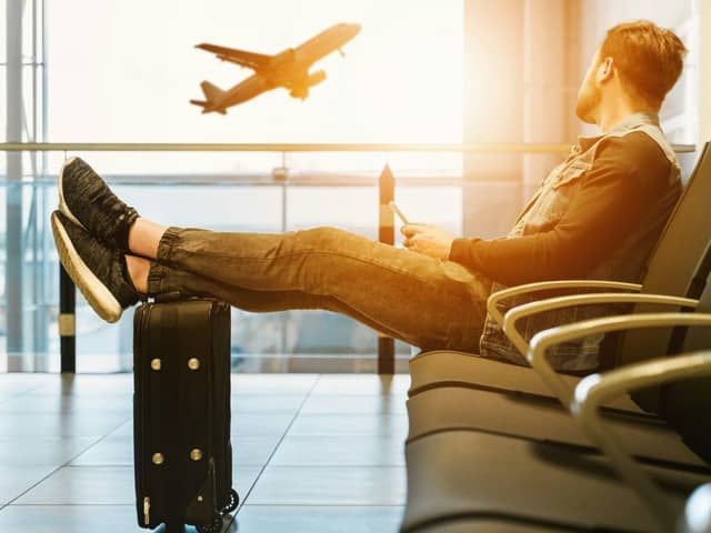 Passenger waits in the departure lounge of an airport