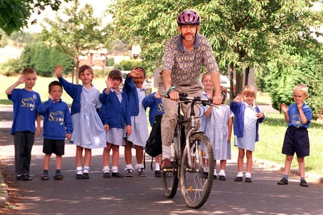 Teacher Richard Benson prepares to cycle home from Armthorpe Southfield Primary School, waved off by some of his pupils, July 1999