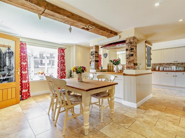 The kitchen diner is bright and spacious, with an island unit.
