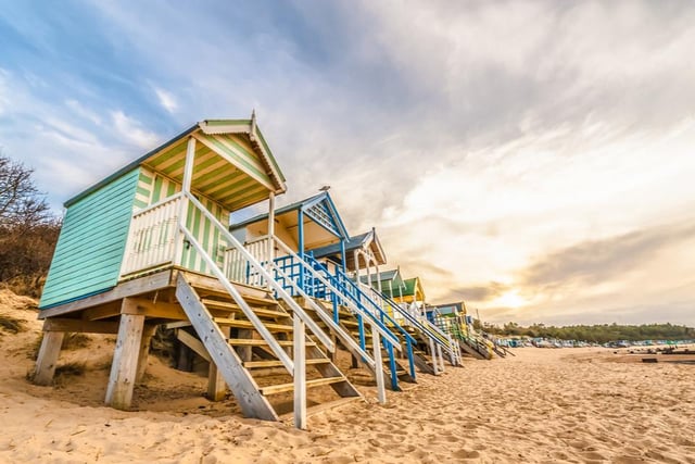 Lined by colourful huts, this pretty beach offers a wealth of space to play on the sand and paddle in the sea, and is open to dog walkers, subject to certain restrictions.