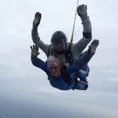 A staff member skydives for the NHS 75 in October.
