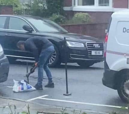 A council worker tries to fix the hole.