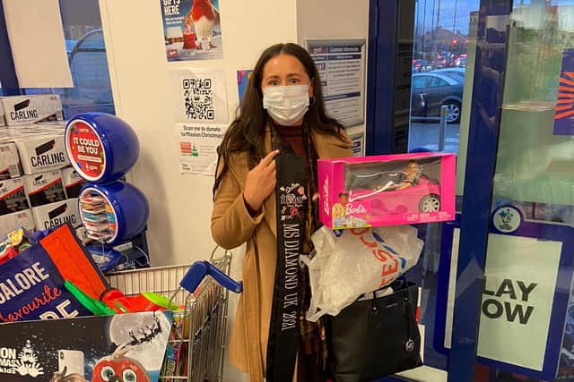 Charlotte Lister collecting toys for children.