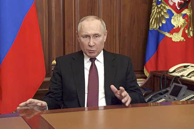 In this image made from video released by the Russian Presidential Press Service, Russian President Vladimir Putin addressees the nation in Moscow, Russia, Thursday, Feb. 24, 2022. Russian troops launched their anticipated attack on Ukraine on Thursday, as Putin cast aside international condemnation and sanctions and warned other countries that any attempt to interfere would lead to "consequences you have never seen."  (Russian Presidential Press Service via AP)