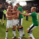 James Coppinger (centre) celebrates after scoring the goal to secure the League One title, with David Cotterill, Tommy Spurr and Dave Syers