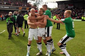 James Coppinger (centre) celebrates after scoring the goal to secure the League One title, with David Cotterill, Tommy Spurr and Dave Syers