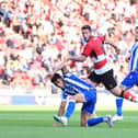 Doncaster's Tommy Rowe has his shot blocked.