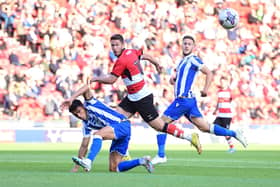 Doncaster's Tommy Rowe has his shot blocked.