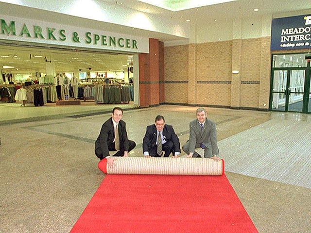 Marks & Spencer Meadowhall rolled out the red carpet for customers at the Meadowhall Centre for the opening of the new link between the Interchange bridge at the front of the store in 1999. Left to right, Darren Pearce, Finance Manager at Meadowhall Centre, Peter Walker, South Yorkshire Passenger Executive and Stefan Andrejczuk, M & S Meadowhall Store Manager.