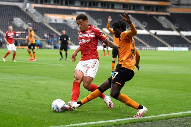 Middlesbrough's Marcus Tavernier battles for possession with Hull City's Leonardo Da Silva Lopes.