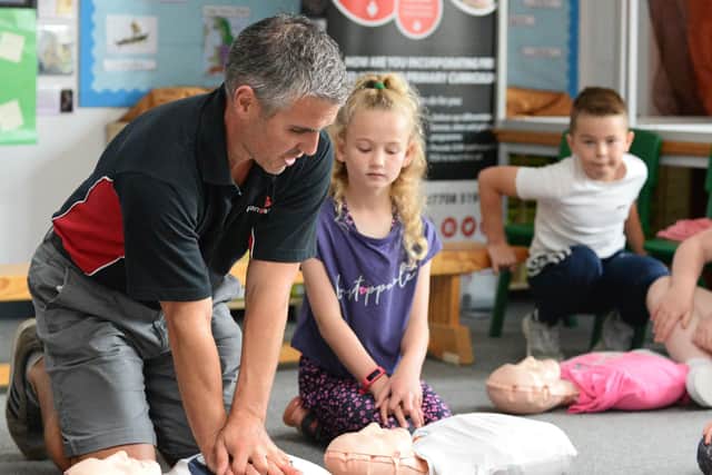 Sam Clark of I Can Save A Life demonstrates CPR to pupils at Carr Lodge Academy