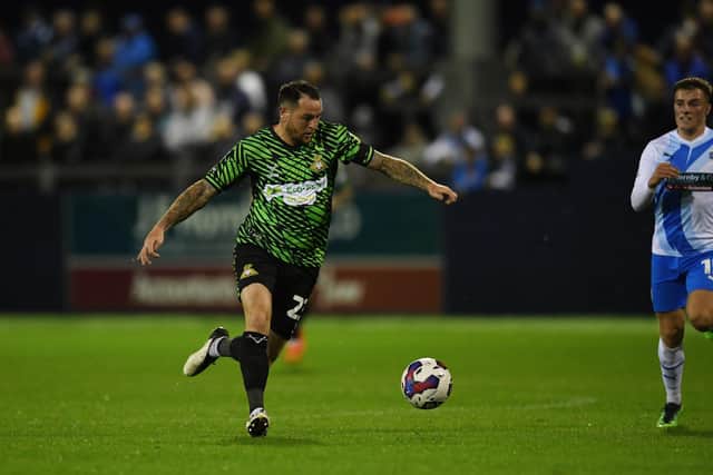 Doncaster's Lee Tomlin drives forward with the ball against Barrow.