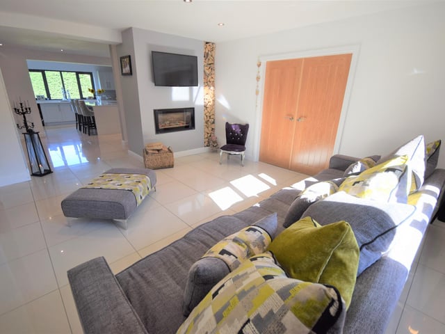 In this sitting room, there is a built in log burner, tiles to the floors, double glazed windows and a double door into the playroom. This sitting room is situated just off from the kitchen, which makes it a great place to relax after a lovely meal.