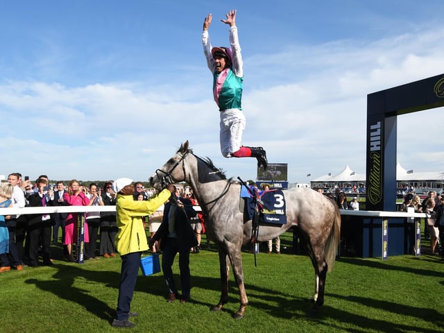 Frankie Dettori riding Logician celebrates with his trademark flying dismount after winning the William Hill St Leger Stakes during St Leger Day at Doncaster Racecourse on September 14, 2019 . (Photo by George Wood/Getty Images)
