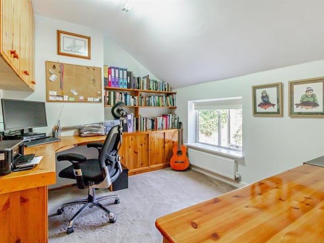 A home office or study with fitted cabinetry.
