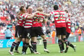 The Rovers side celebrate with goalscorer James Hayter. Picture: Marie Caley