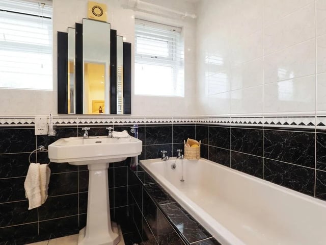 A tiled monochrome bathroom.